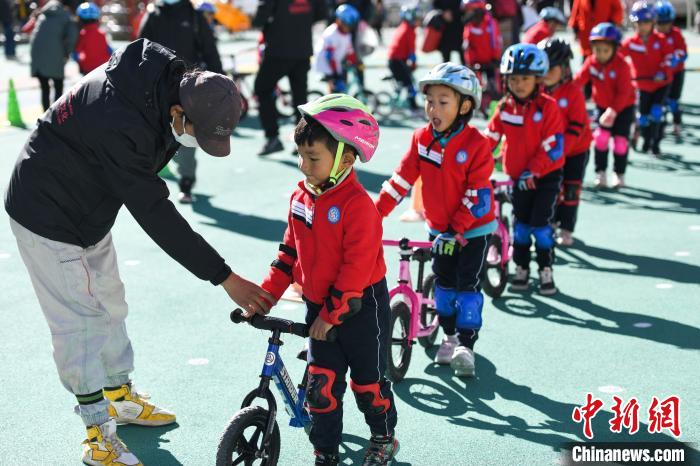 圖為拉薩市實(shí)驗(yàn)幼兒園孩子們在教練的指導(dǎo)下練習(xí)滑步車。　何蓬磊 攝