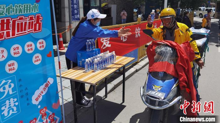 圖為近日，西藏自治區(qū)青年志愿者協(xié)會志愿者在拉薩街頭向快遞員送水。西藏自治區(qū)青年志愿者協(xié)會 供圖