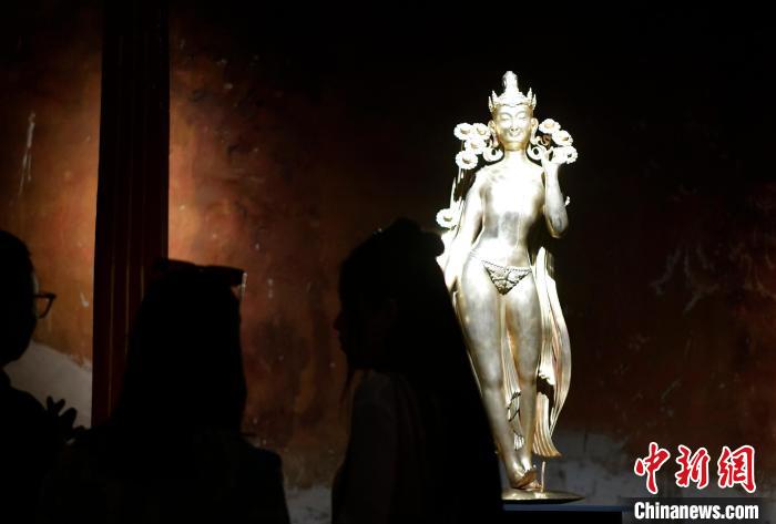 圖為觀眾正在欣賞展覽中的雕塑作品《八萬四千年》?！±盍?攝